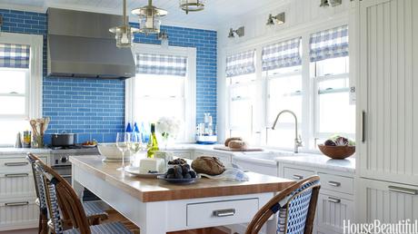 A blue tile backsplash takes over one whole wall in this Fire Island kitchen designed by Marshall Watson. Veneto glass tiles from Stone Source. 