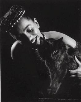 Gjon Mili's cat Blackie being hugged by nightclub entertainer Maune de Revel