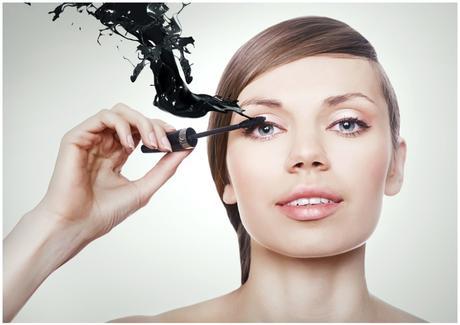 woman with mascara brush and black splash