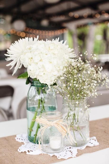Rustic/vintage wedding centerpiece with mason jars, baby's breath, mums, and hydrangeas with burlap table runner by Lucky in Love vintage event rentals of San Antonio, TX. www.luckyinlovesa.com: 