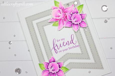 White embossed flowers colored with Zig Clean Color Brush Markers