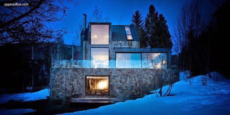 Casa de montaña rústica de piedra, acero y madera.
