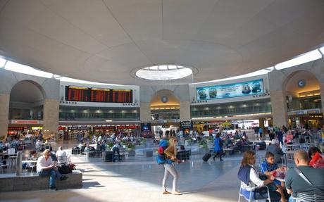 Busy central waiting area at modern major airport