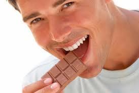 Atractivo muchacho mordiendo un chocolate