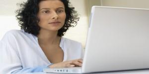 Woman Using Laptop --- Image by © Royalty-Free/Corbis