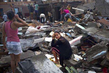 A woman cries amid the rubble of her home, destroyed by Hurricane Matthew in Baracoa, Cuba, Wednesday, Oct. 5, 2016. The hurricane rolled across the sparsely populated tip of Cuba overnight, destroying dozens of homes in Cuba's easternmost city, Baracoa, leaving hundreds of others damaged.  (AP Photo/Ramon Espinosa)