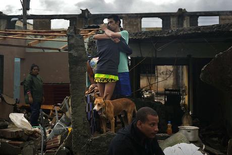 A couple embrace in the remains of their home that was destroyed by Hurricane Matthew in Baracoa, Cuba, Wednesday, Oct. 5, 2016. The hurricane rolled across the sparsely populated tip of Cuba overnight, destroying dozens of homes in Cuba's easternmost city, Baracoa, leaving hundreds of others damaged.  (AP Photo/Ramon Espinosa)