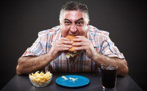 greedy-overweight-man-eating-junk-food