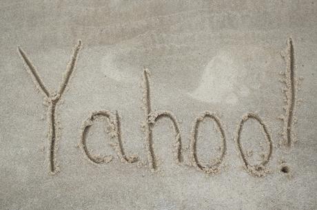 Word Yahoo written on sand by stick