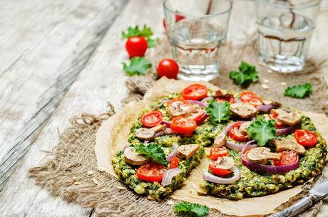 Kale oats pizza crust with tomato, red onion and mushrooms