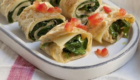 Resultado de imagen de Tortillas francesas rellenas de queso Tortillas francesas rellenas de queso 4 de junio de 2017, 08:00 4 per. 25 min. 349 cal.  5 huevos 150 g de queso en lonchas 60 g de espinacas 2 tomates Sal, pimienta 4 cucharadas de aceite de oliva  Lava las espinacas, escúrrelas bien y trocéalas. Lava los tomates, pélalos y pícalos. Ponlos en un cuenco y añade sal, pimienta y un chorrito de aceite. Remueve con dos cucharas. Bate los huevos ligeramente y salpimiéntalos. Calienta un poco de aceite en una sartén y vierte un cucharón de huevo batido (tiene que cubrir toda la sartén formando una capa fina). Pasados 1 o 2 minutos, dale la vuelta y termina la cocción. Repite la operación con el resto del huevo. Calienta un poco de aceite en una sartén, saltea las espinacas 2 minutos y salpimienta. Cubre las tortillas con el queso, pon encima las espinacas y enróllalas. Córtalas en rodajas, reparte sobre ellas el tomate y sírvelas.  El truco: añádele al relleno unas lonchas de jamón dulce o de pavo. Obtendrás un plato más completo sin dejar de ser saludable.
