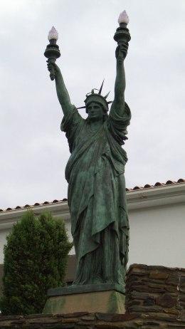 Tocada por la tramontana y el surrealismo (serie “Las damas de la libertad: las estatuas de Miss Liberty alrededor del mundo”)