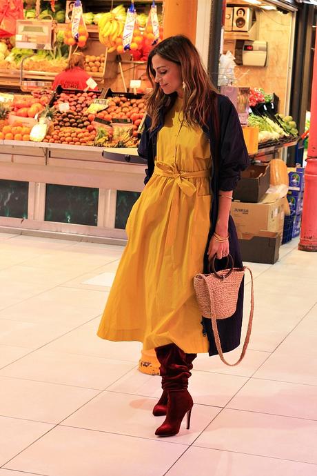 vestido midi amarillo y botas altas con parka