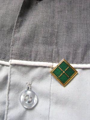 An ITIL Foundation Certificate pin on a shirt.