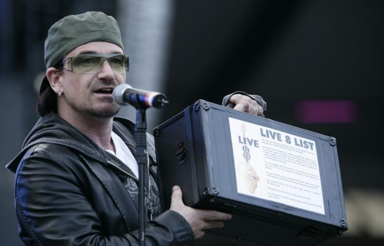 Bono addresses the crowd at the Long Walk to Justice concert on the eve of G8