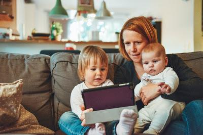Madre con niños pequeños y una tablet