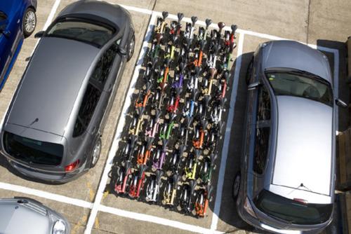 aerial view of 42 brompton folding bicycles occupying a parking...