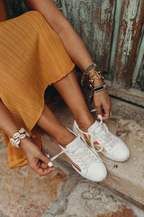 Sara of Collage Vintage wearing a long mustard dress and embroidered sneakers