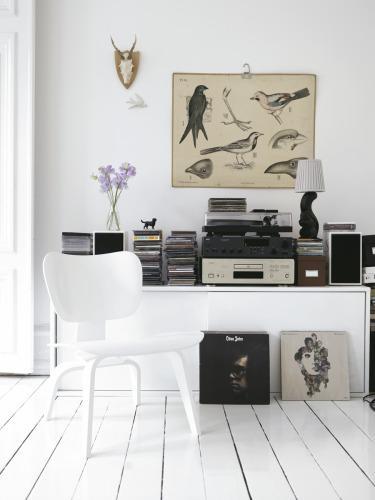 suelo de parquet blanco sofa blanco silla mecedora eames negro silla eames eiffel blanca mesa de centro fritz hansen lámparas de papel de arroz habitación infantil lila grandes ventanales estilo nórdico estilo escandinavo diseño de interiores decoración sueca decoración en blanco decoración de interiores bola de espejos bola de discoteca 