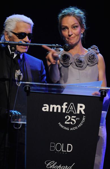 Karl Lagerfeld and  Uma Thurman onstage at amfAR's Cinema Against AIDS Gala during the 64th Annual Cannes Film Festival at Hotel Du Cap on May 19, 2011 in Antibes, France.