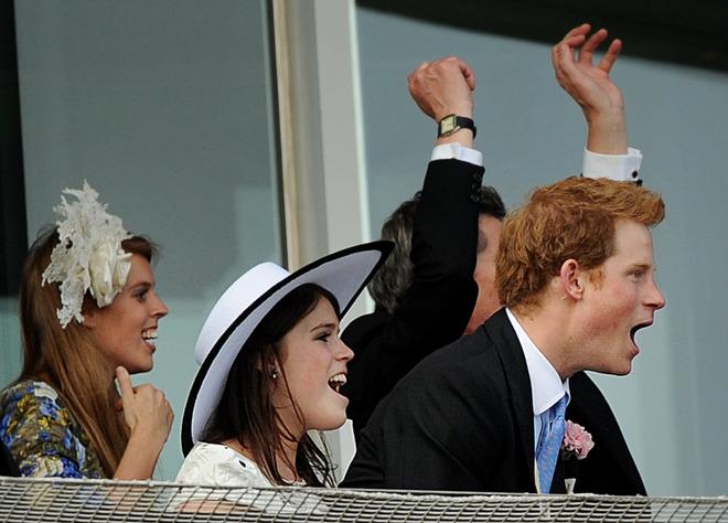 Britain's Princesses Of York, Eugenie (L) And Beatrice (C) And Prince Harry Cheer