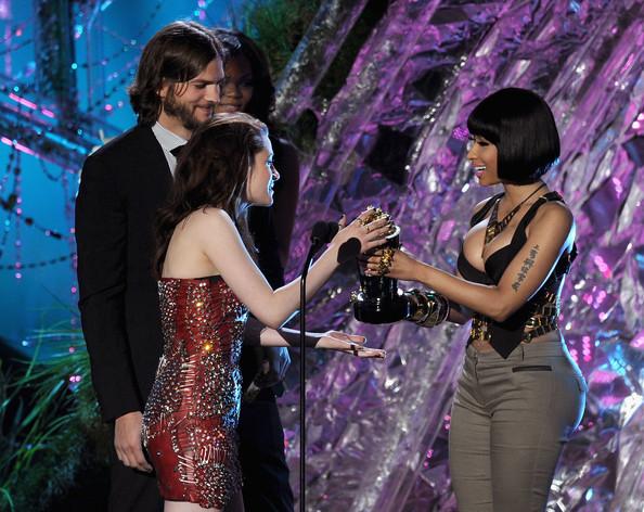 Kristen Stewart Actress Kristen Stewart accepts the Best Female Performance award from actor Ashton Kutcher and Nicki Minaj onstage during the 2011 MTV Movie Awards at Universal Studios' Gibson Amphitheatre on June 5, 2011 in Universal City, California.