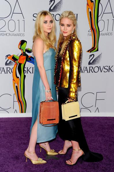 Designers Ashley Olsen (L) and Mary-Kate Olsen attend the 2011 CFDA Fashion Awards at Alice Tully Hall, Lincoln Center on June 6, 2011 in New York City.
