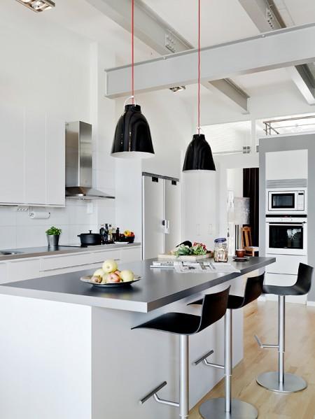 Aires de loft en un sexto piso vigas de metal piso nórdico muebles de balcón loft lámparas de estilo industrial grandes ventanales diseño de interiores decoración sueca decoración nórdica cocinas modernas cocinas blancas barra en la cocina