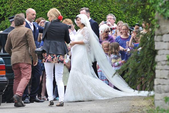 Lily Allen THE HAPPY COUPLE! Lily Allen and Sam Cooper emerge from St James The Great Church in Cranham after their wedding. Lily was wearing a Chanel lace dress created by Karl Lagerfeld and was looking estatically happy following her marriage to Sam.  The singer-turned-businesswoman was carrying a bouquet with a knitted bride and groom hanging from the stems.