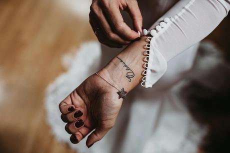 Boda de otoño en el Pirineo Novia con tatuaje en la muñeca manga de tul con botones