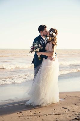 Pareja de novios besándose en la playa