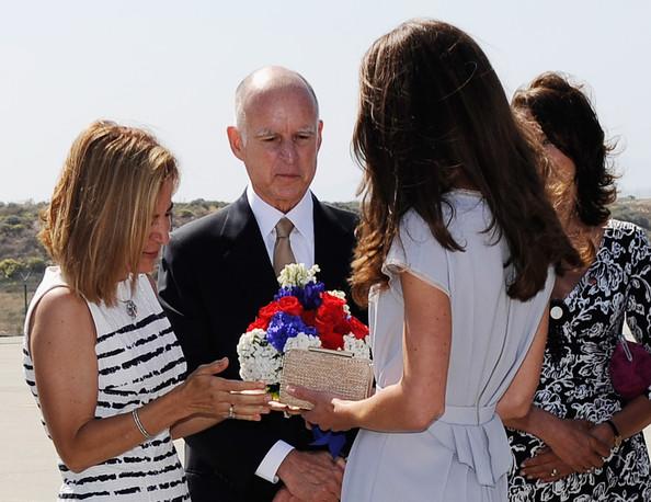 Anne Gust, wife of  California Governor Jerry Brown, gives a red white and blue bouquet of flowers to Catherine, Duchess of Cambridge after she and Prince William, Duke of Cambridge, arrive at Los Angeles International Airport on July 8, 2011 in Los Angeles, California. The newly married Royal Couple are on a three day visit to Southern California.