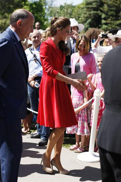The Duke and Duchess of Cambridge attend a reception hosted by the Government of Alberta at the Enmax Conservatory. To commemorate the visit of the Royal couple,  the Government of Canada announced the creation of the $50,000 Duke and Duchess of Cambridge Scholarship. While departing the conservatory the couple shook hands with onlookers and Kate accepted flowers from fans. Kate Middleton is seen wearing a satin and wool scarlet Marianne coat dress by Catherine Walker with The Queen's Maple Leaf Brooch. .