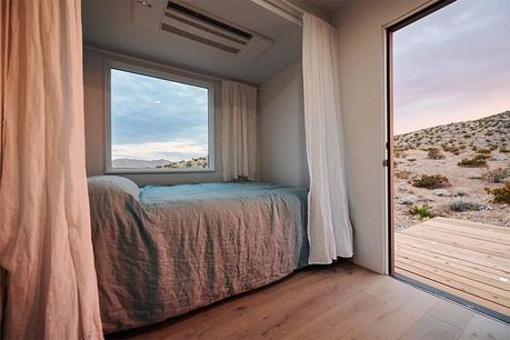 wood decks vanity area storage picture window modern shipping container house main bedroom living room kitchen Joshua Tree guest suite container color palette white casas recicladas casas modernas casa con contenedores casa con containers california bi-folding doors bathroom airbnb  