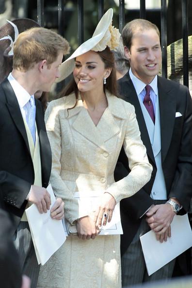 Catherine, Duchess of Cambridge, chats with her brother-in-law Prince Harry as they leave the Canongate Kirk on Edinburgh's historic Royal Mile following the wedding of Zara Phillips and Mike Tindall.