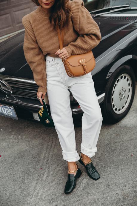 Sara from Collage Vintage wearing a camel Isabel Marant cashmere pullover and white Agolde jeans
