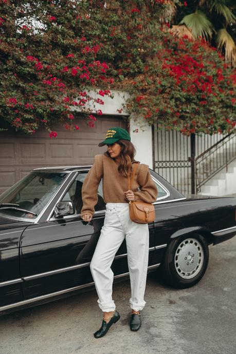 Sara from Collage Vintage wearing a camel Isabel Marant cashmere pullover and white Agolde jeans