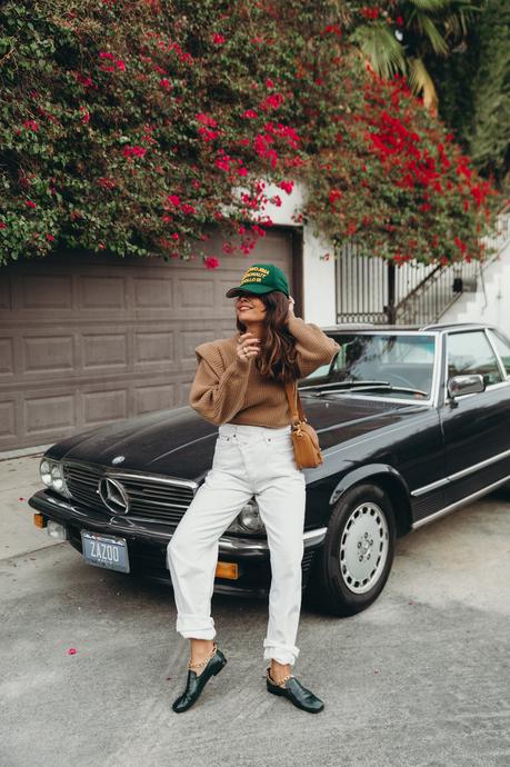 Sara from Collage Vintage wearing a camel Isabel Marant cashmere pullover and white Agolde jeans