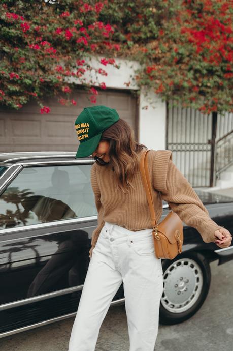 Sara from Collage Vintage wearing a camel Isabel Marant cashmere pullover and white Agolde jeans