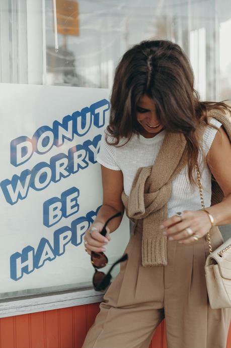 Donut worry be happy! Sara from Collage Vintage wearing a camel pullover and pleated high waist trousers from Closed