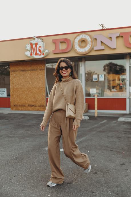 Donut worry be happy! Sara from Collage Vintage wearing a camel pullover and pleated high waist trousers from Closed