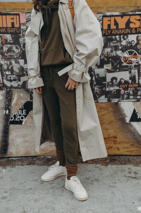 Sara from Collage Vintage wearing a Nili Lotan set in army green paired with a vintage trench coat and Reebok retro sneakers