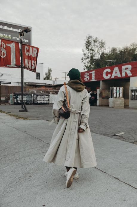 Sara from Collage Vintage wearing a Nili Lotan set in army green paired with a vintage trench coat and Reebok retro sneakers