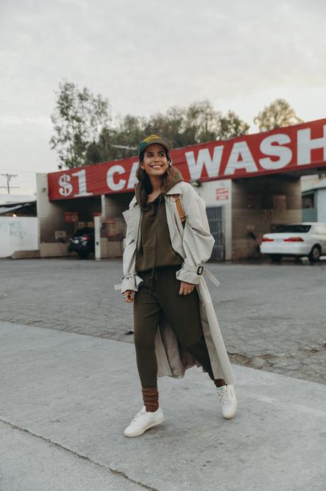 Sara from Collage Vintage wearing a Nili Lotan set in army green paired with a vintage trench coat and Reebok retro sneakers