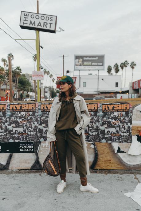 Sara from Collage Vintage wearing a Nili Lotan set in army green paired with a vintage trench coat and Reebok retro sneakers