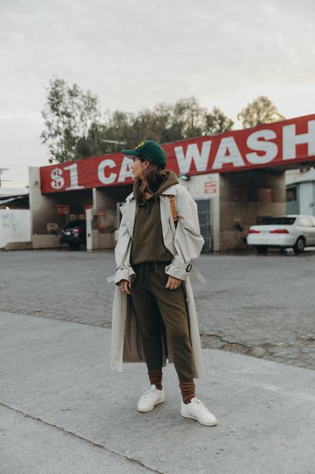 Sara from Collage Vintage wearing a Nili Lotan set in army green paired with a vintage trench coat and Reebok retro sneakers