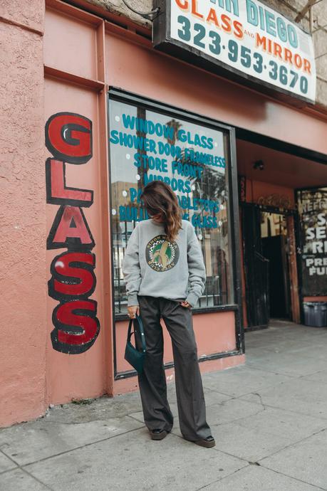 Sunday at antiques stores wearing a Simon Miller Sweatshirt and mini Puffin bag