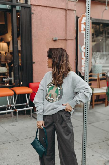 Sunday at antiques stores wearing a Simon Miller Sweatshirt and mini Puffin bag