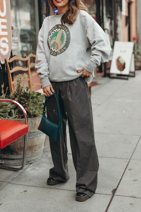 Sunday at antiques stores wearing a Simon Miller Sweatshirt and mini Puffin bag