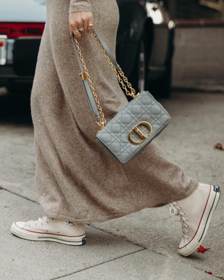 Sara from Collage Vintage wearing a midi knit dress, all star sneakers and cloud blue Caro Dior bag